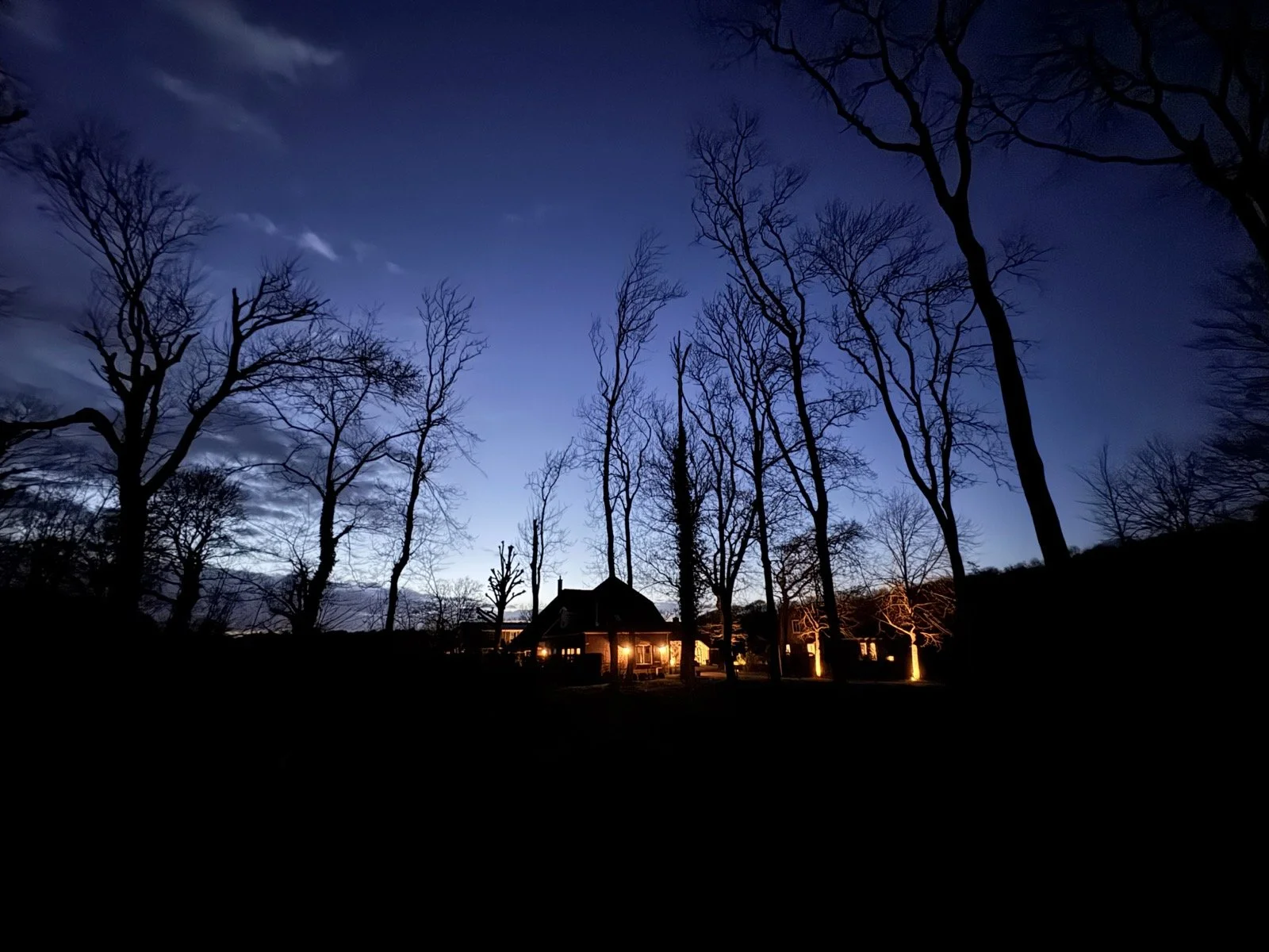 The warm light of heart opening work - our retreat center aglow at dusk.