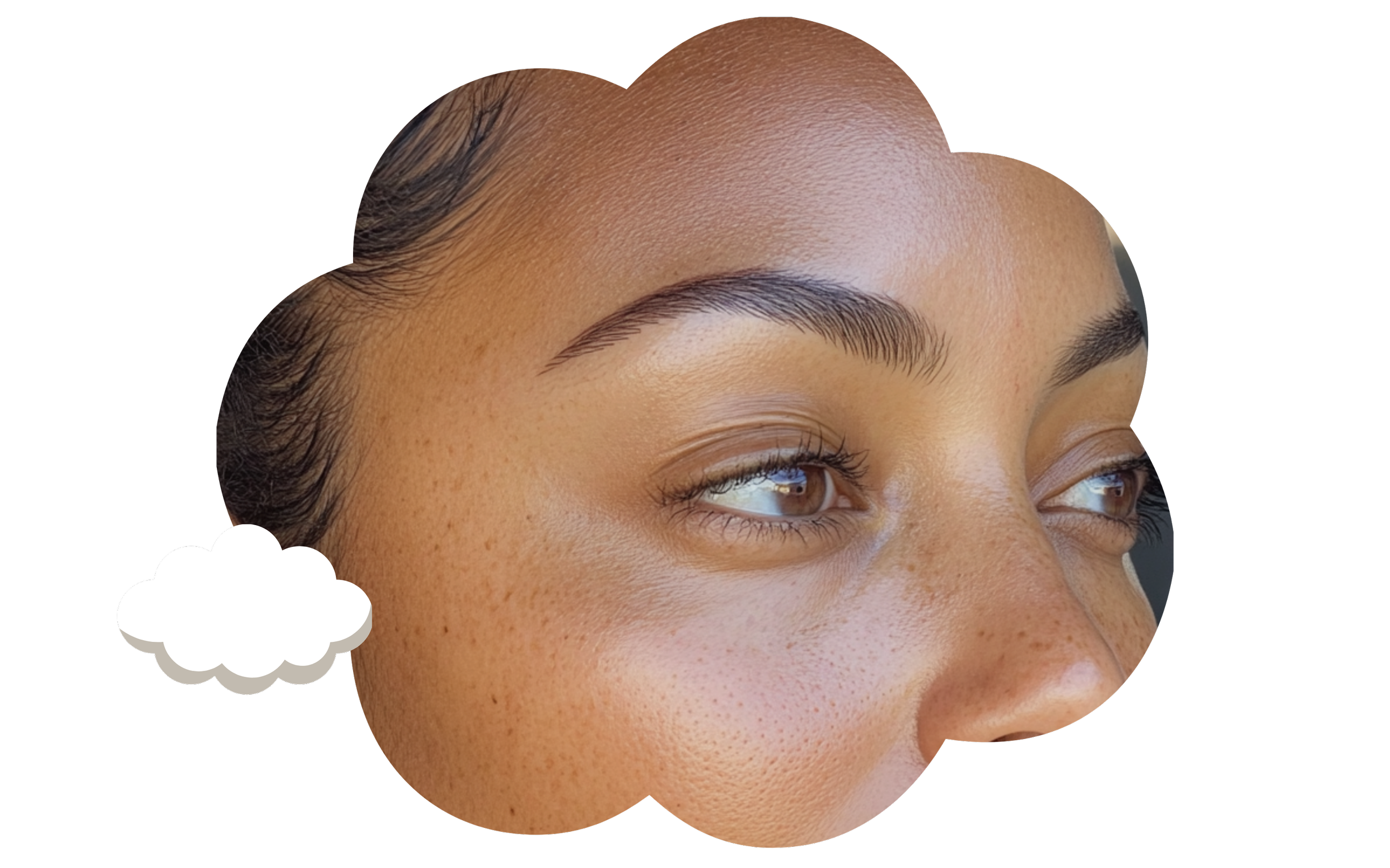 Close-up of a woman's face with well-groomed eyebrows, clear skin with freckles, and light brown eyes, framed within a cloud-shaped border.