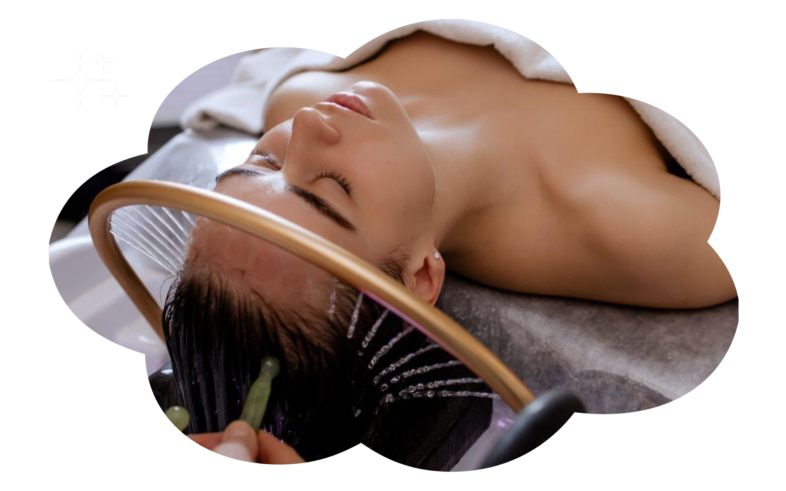 A woman receiving a spa hair treatment, with her head shampooed and rinsed.