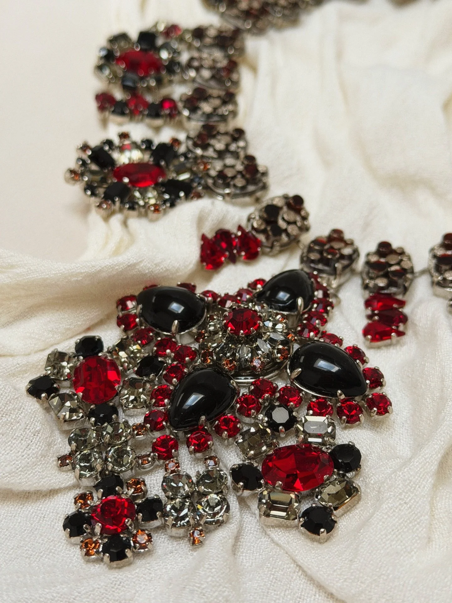 A rare treasure straight from the archives ✨

One-of-a-kind sample piece from Dior &mdash; where craftsmanship meets drama in every detail. Rich crimson stones, inky blacks, and intricate settings make this statement necklace a true collector&rsquo;s