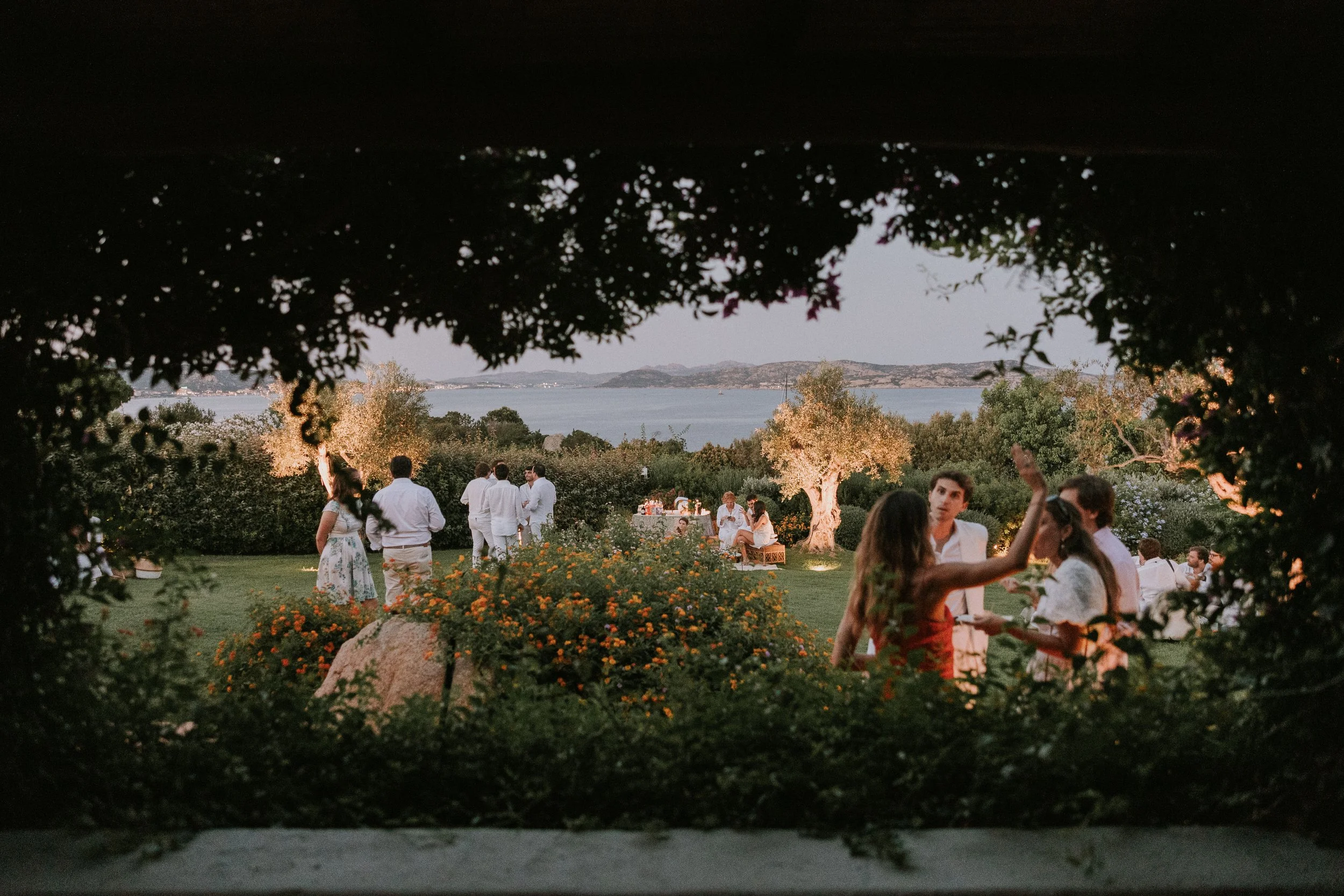 Lighting design for a white-themed wedding welcome dinner in Sardinia