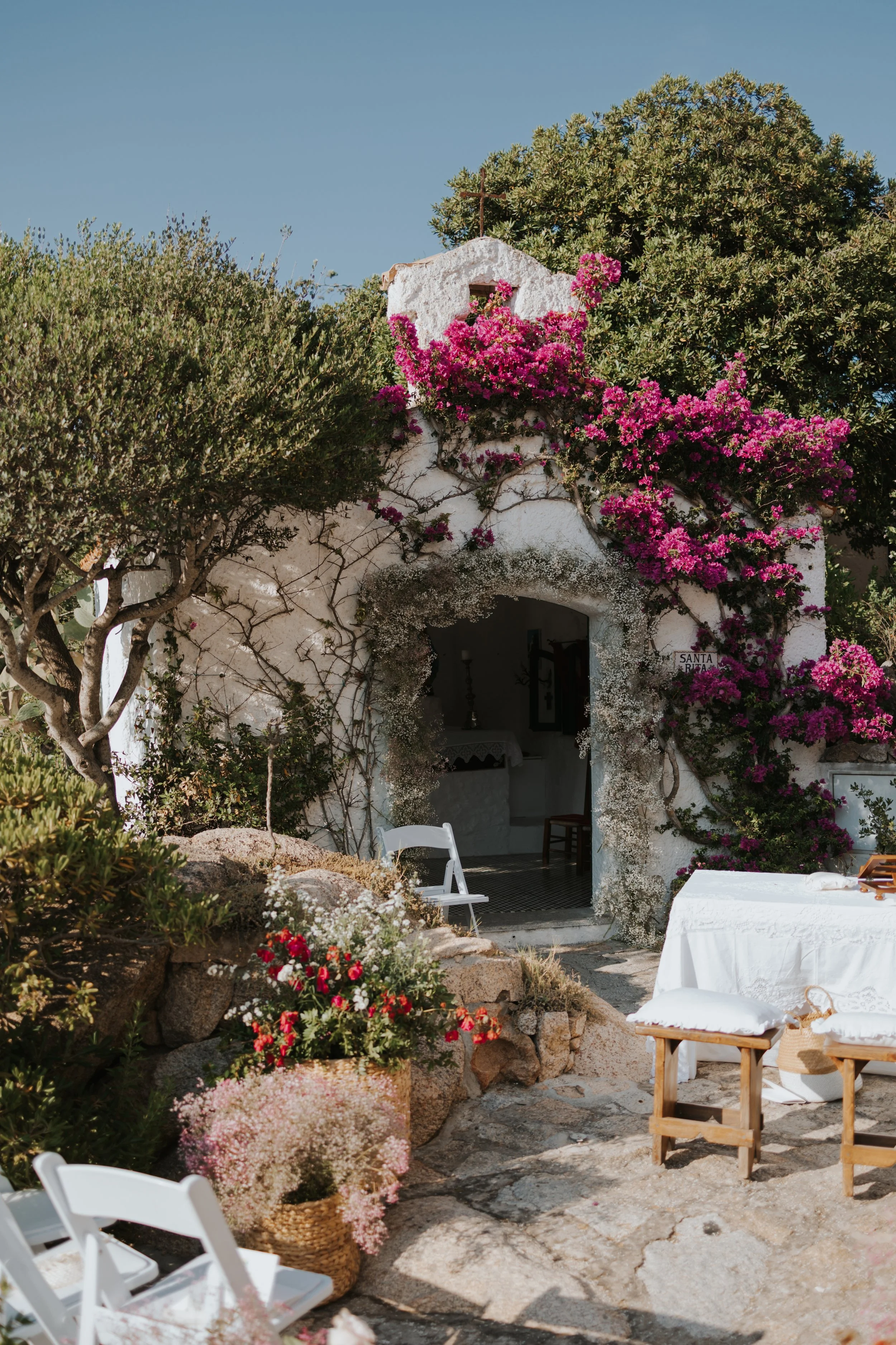 Bougainvillea-covered church wedding setup in Porto Rafael, Sardinia