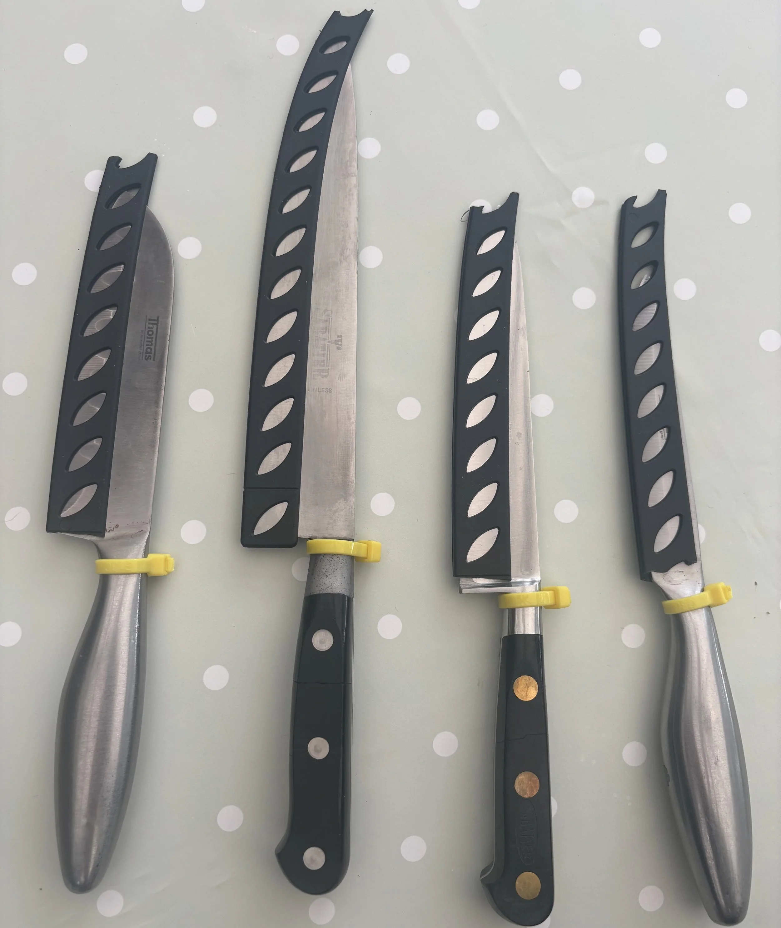 4 Sharpened Knives w/ blade protectors. Each sharp knife marked with a zip tie