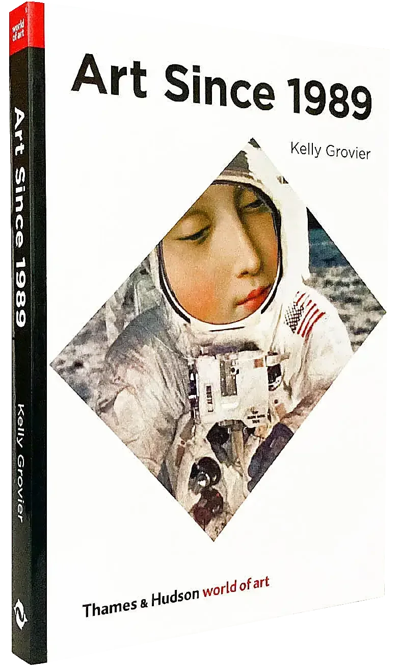 A photograph of a book cover with the title Art Since 1989 ilustrated with an artwork by Aleksandra Mir, her famous astronaut collage with the face of a saint