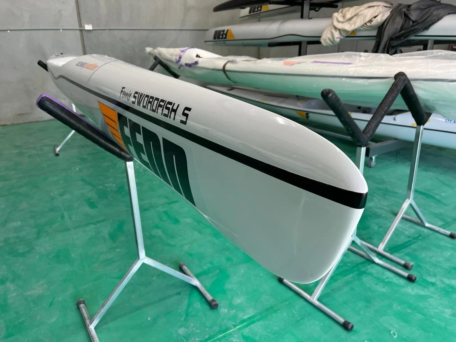 A racing kayak with the words "Family Swordfish 5" and