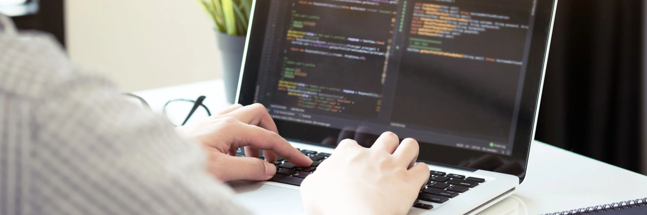 IT person codes on their laptop