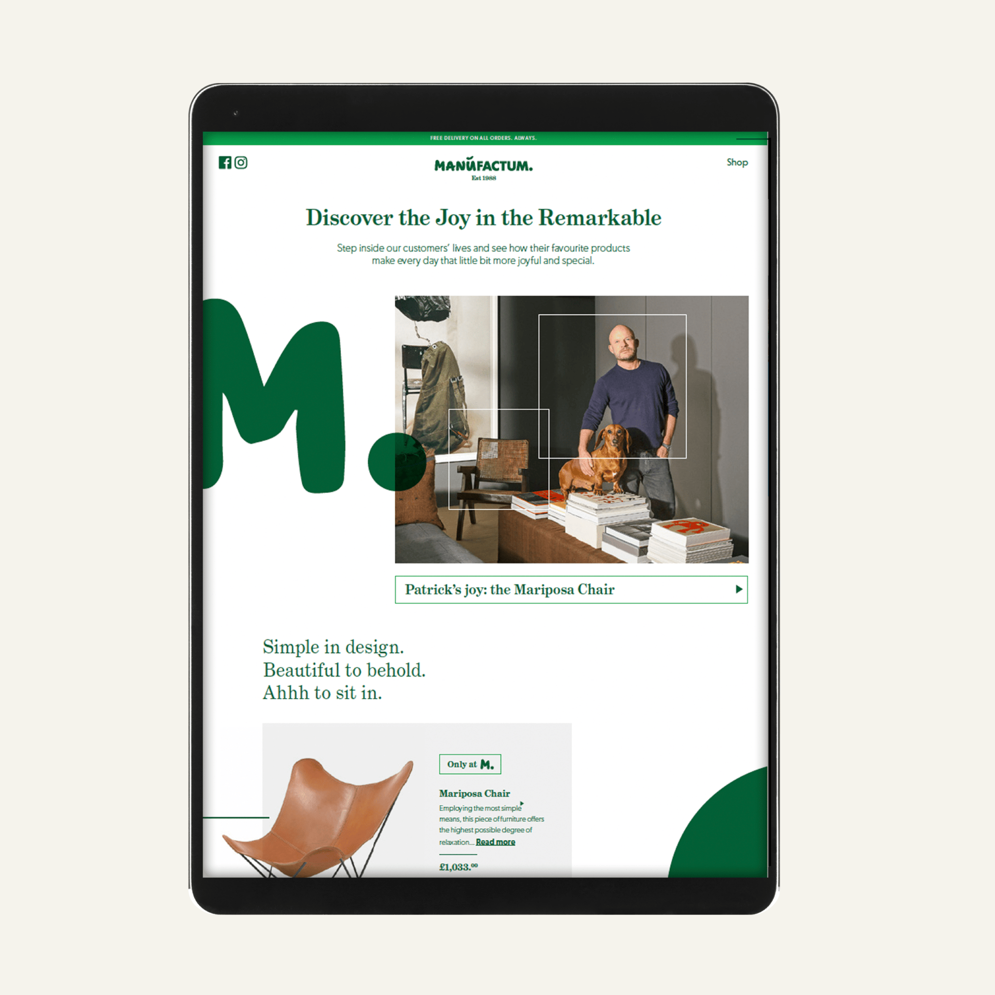 Tablet screen displaying a website for Manufactum with a green and white theme, featuring a man with a dog in a room with furniture, and a product image of a leather Mariposa Chair.