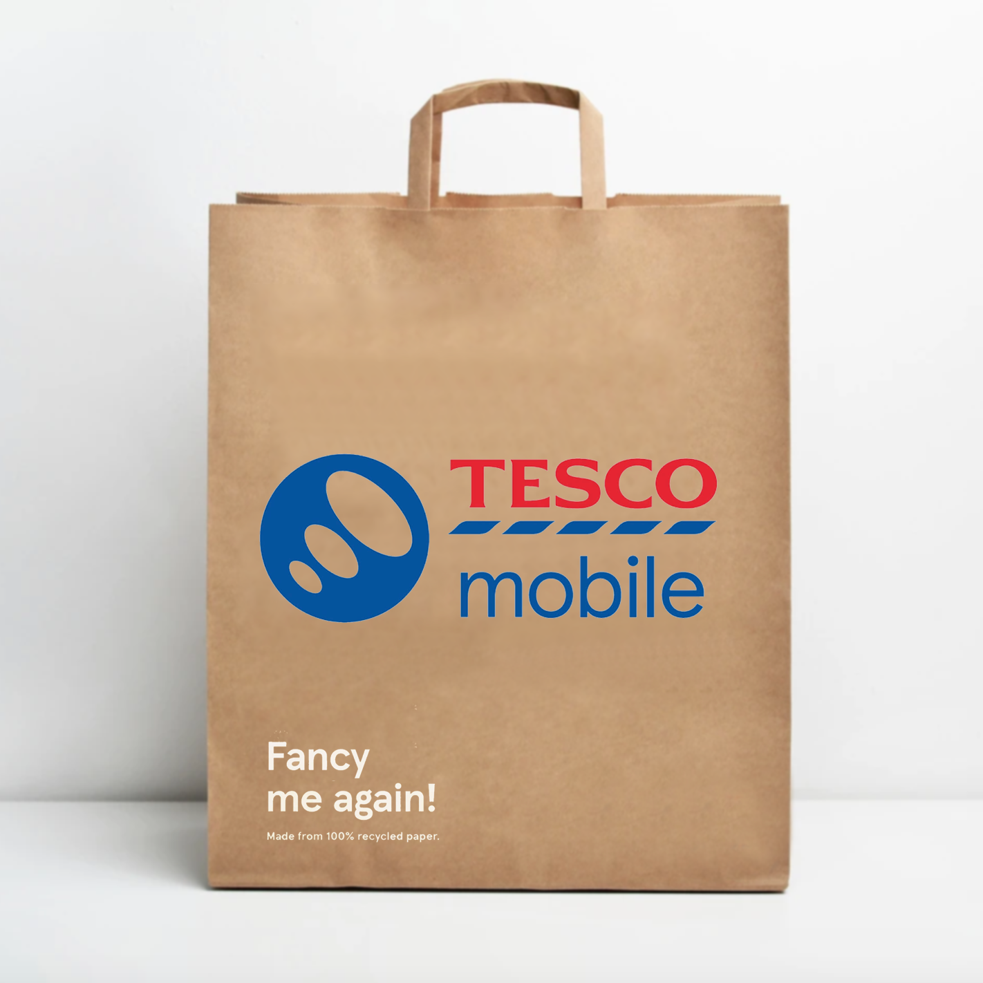 Brown paper shopping bag with Tesco Mobile logo and text, reading "Fancy me again! Made from 100% recycled paper."