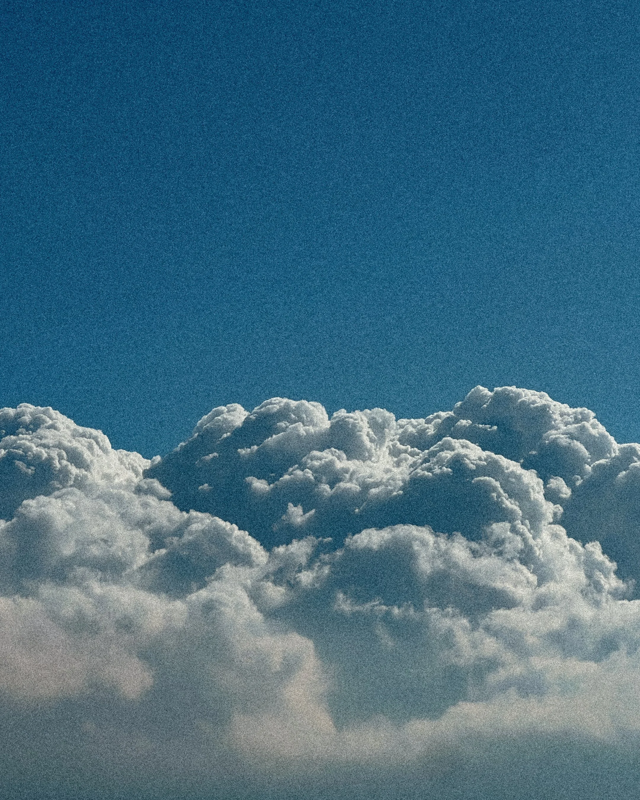 You have uploaded an image of white clouds in a clear blue sky.