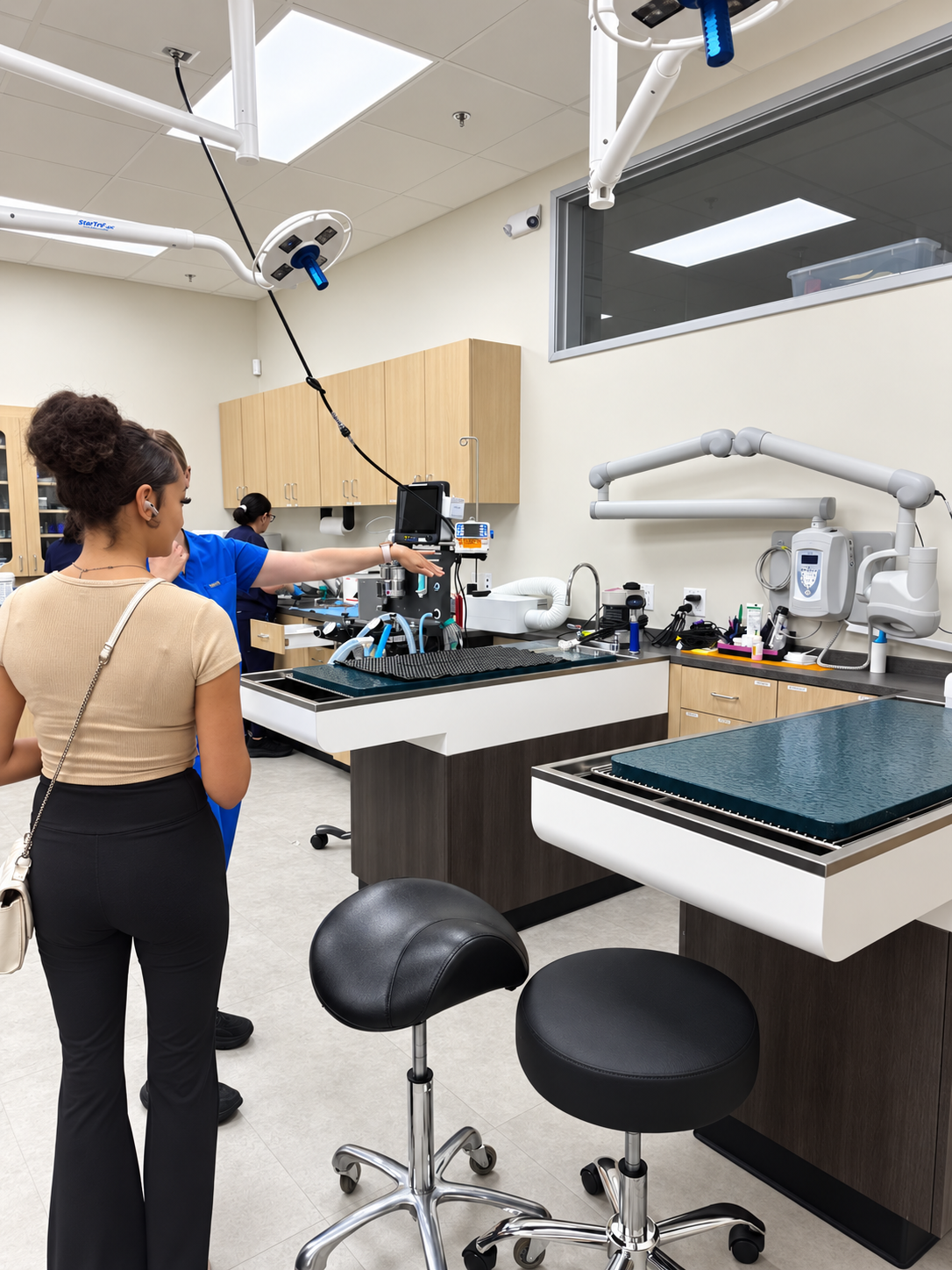 Dr. Hannah Elliott introduces Justice to the equipment and treatment areas used in animal care.