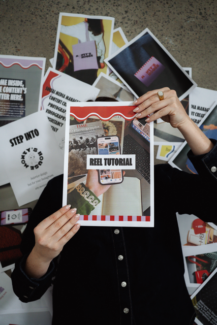 Person holding a flyer for a reel tutorial with photos and posters in the background.