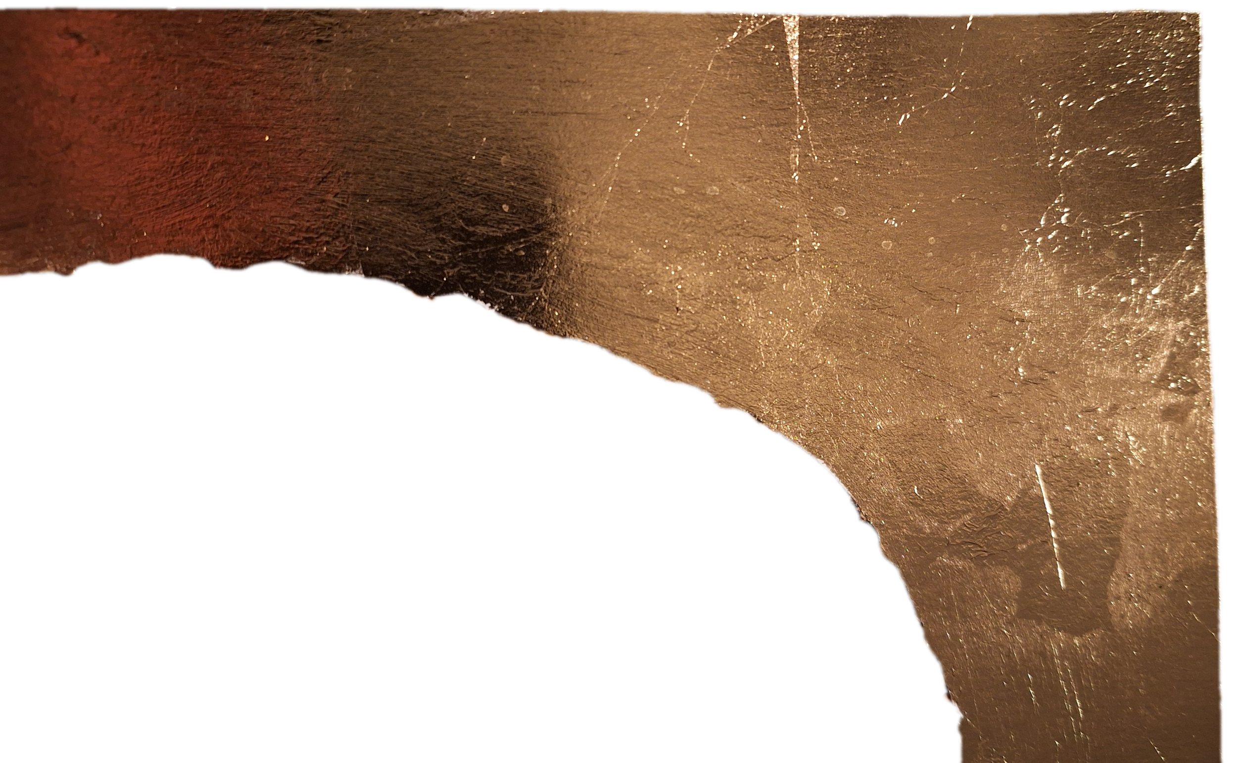 Close-up view of a metallic object with a rough, textured surface, and a curved edge, illuminated by a warm light.