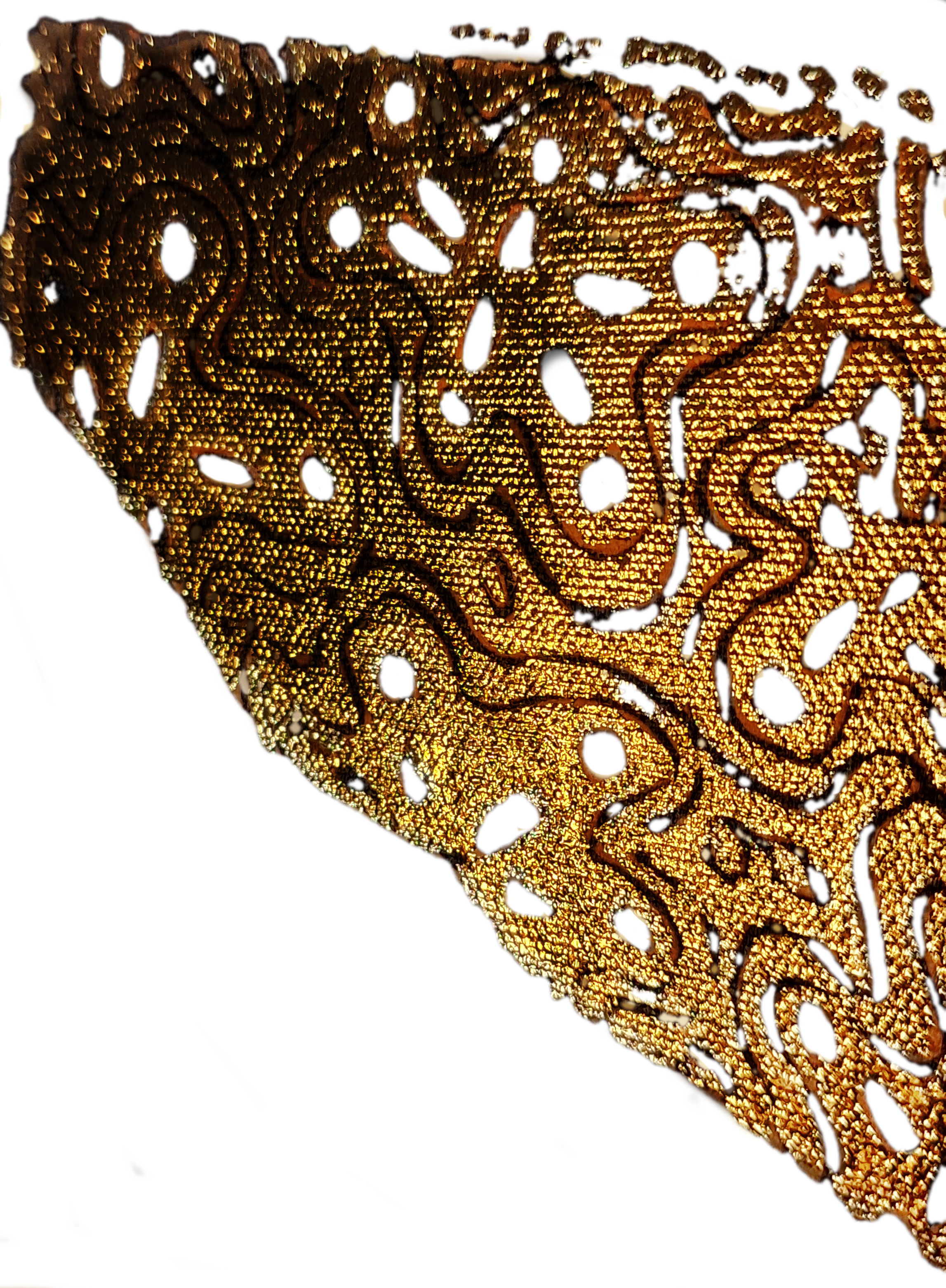 A close-up of an intricately designed, gold-colored decorative object with swirling patterns and cutouts, possibly a piece of jewelry or ornament, set against a black background.