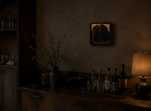 A dark wood sideboard with a vase of green branches, glass bottles, and a lamp in a dimly lit room with a small painting on the wall.