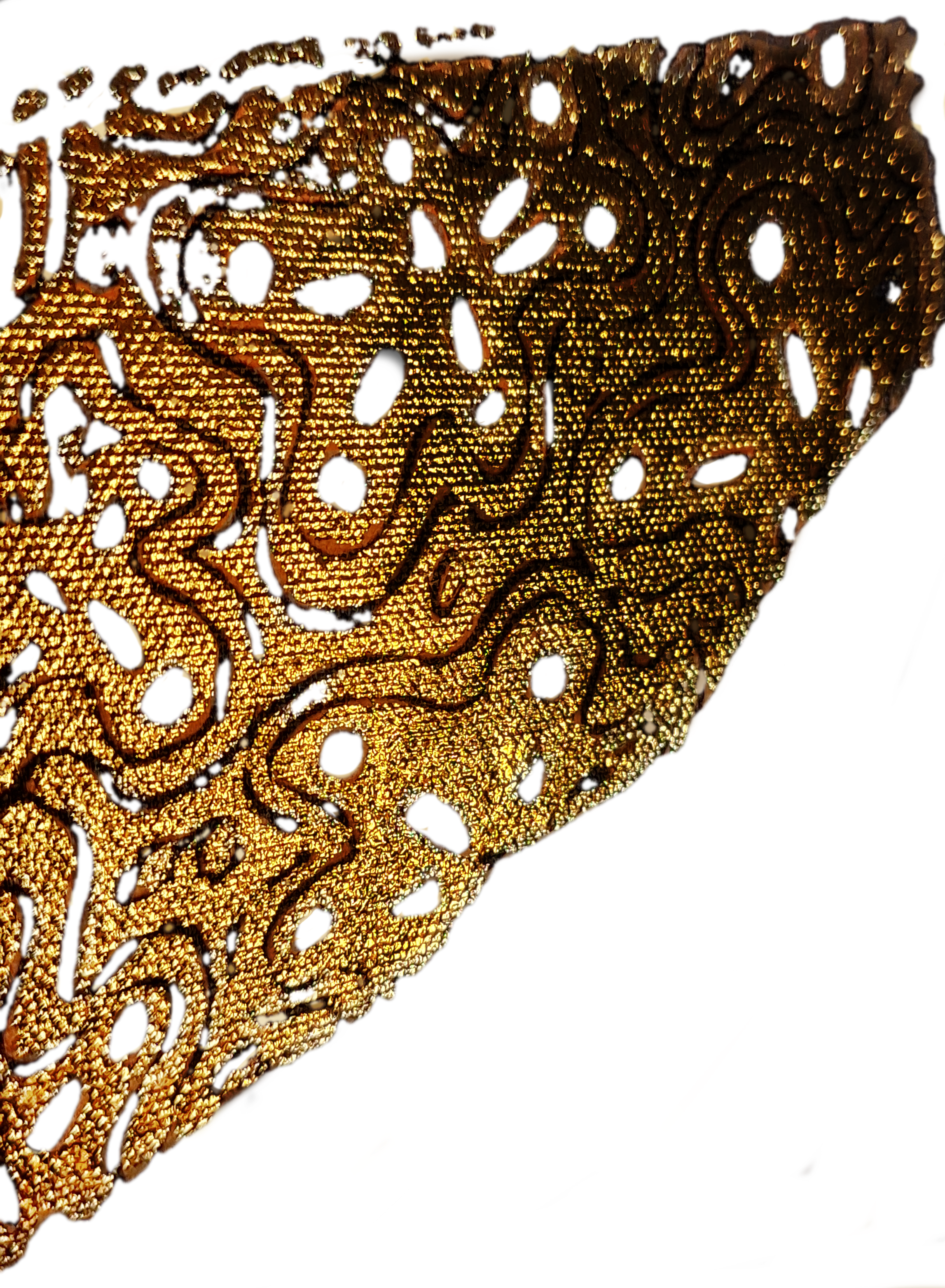 Close-up view of a gold-colored intricately carved decorative object with swirling patterns.
