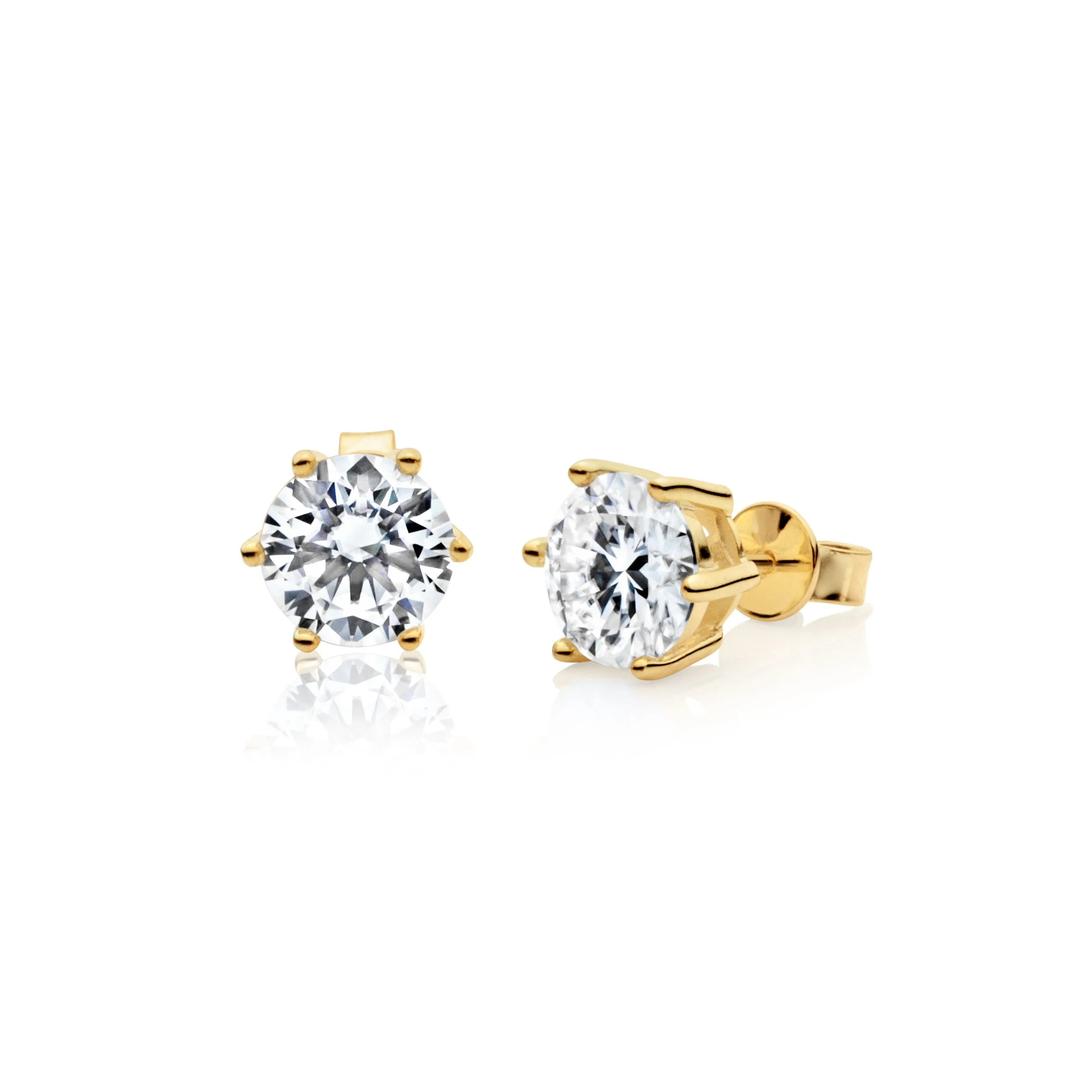 Gold stud earrings with large round clear gemstones.