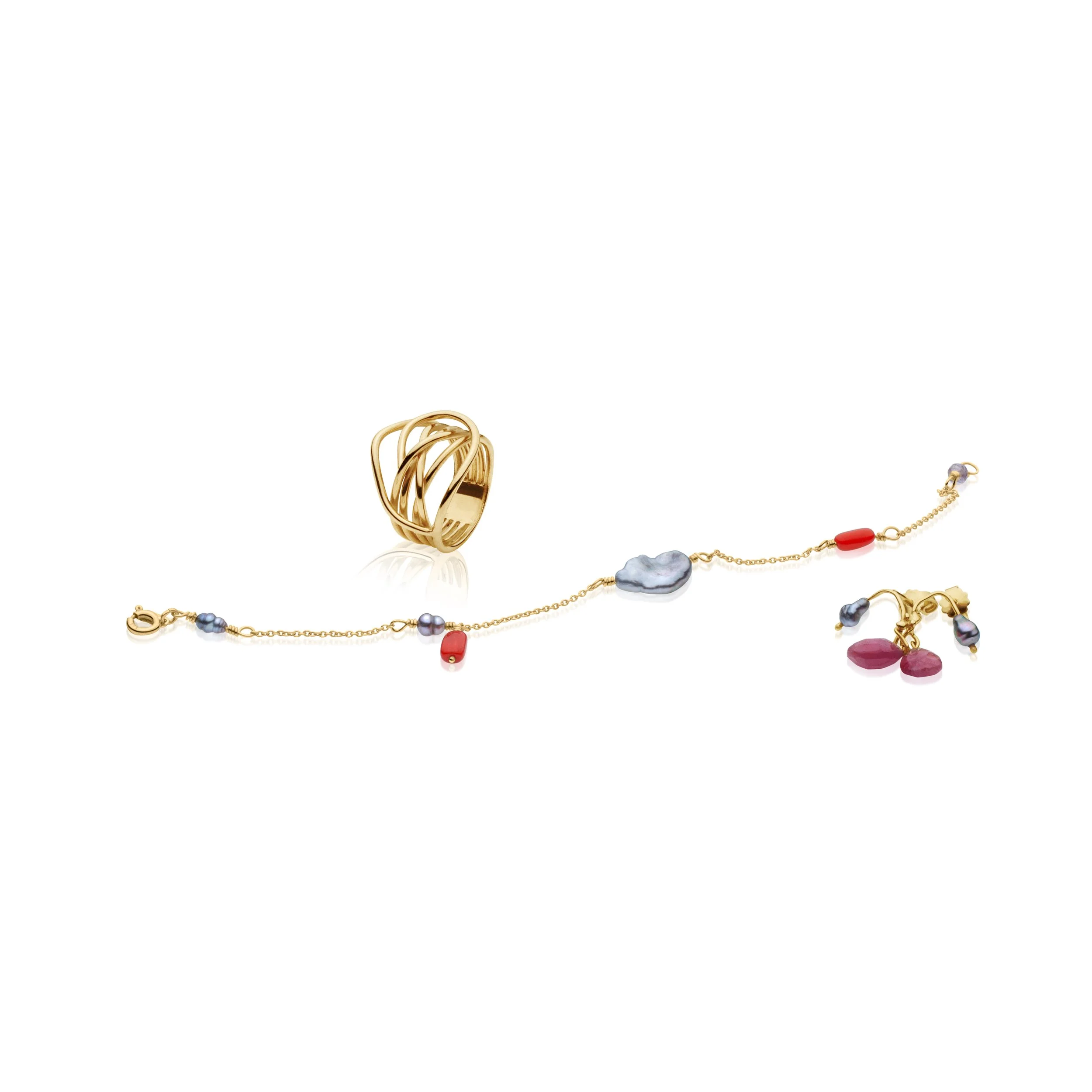 Professional jewelry picture of gold jewelry with colorful stones, including a ring, bracelet, and earrings on a white background.