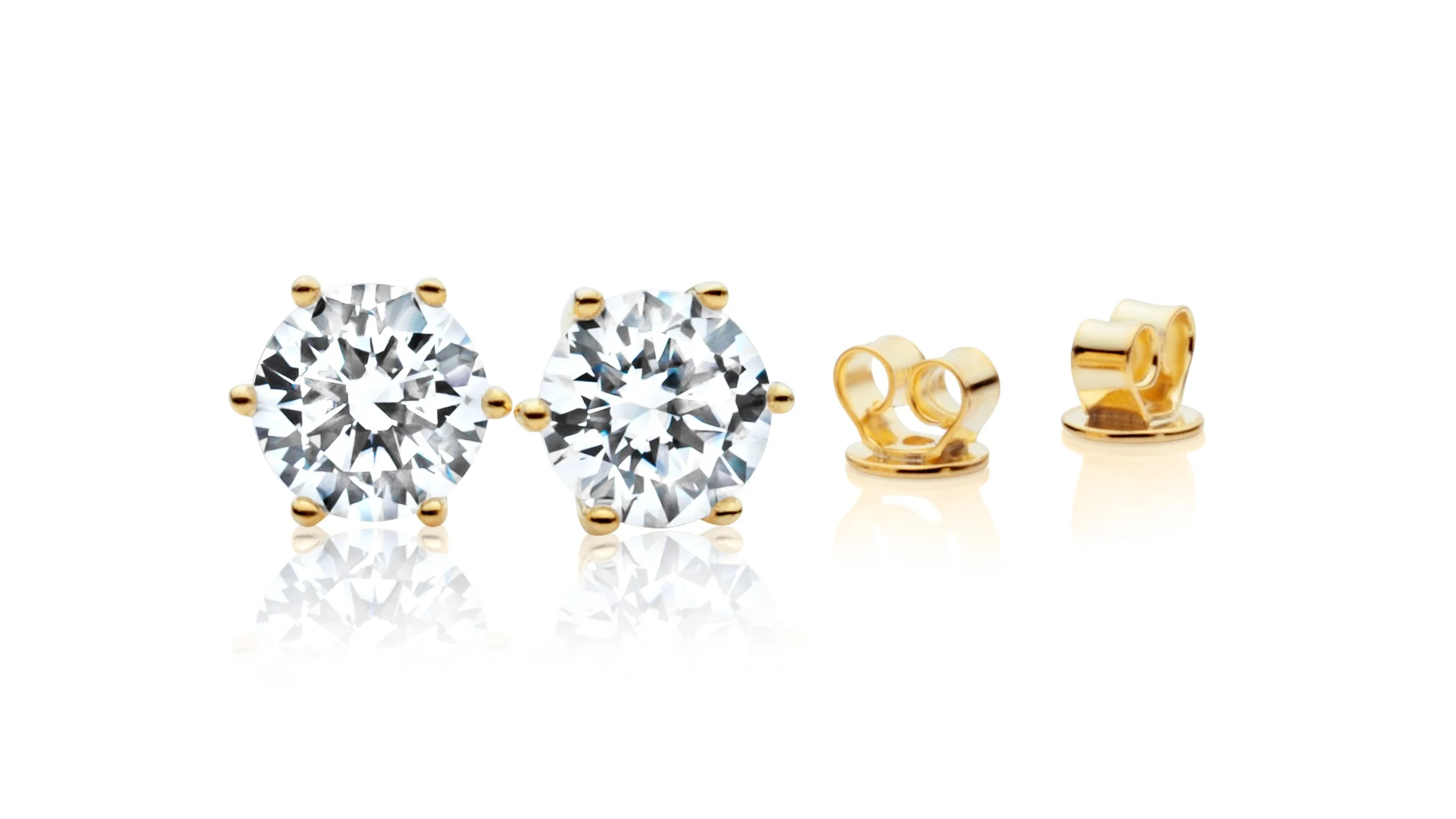 Professional jewelry picture of a set of diamond stud earrings with gold settings, with visible butterfly backs on a white background.