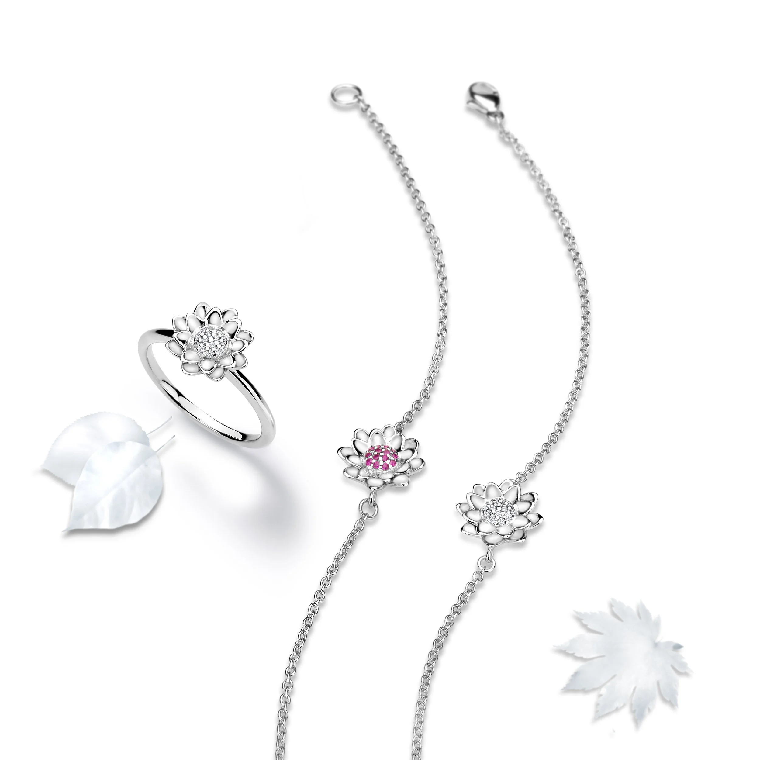 Styled packshot of a gold ring and two bracelets with pave set stones