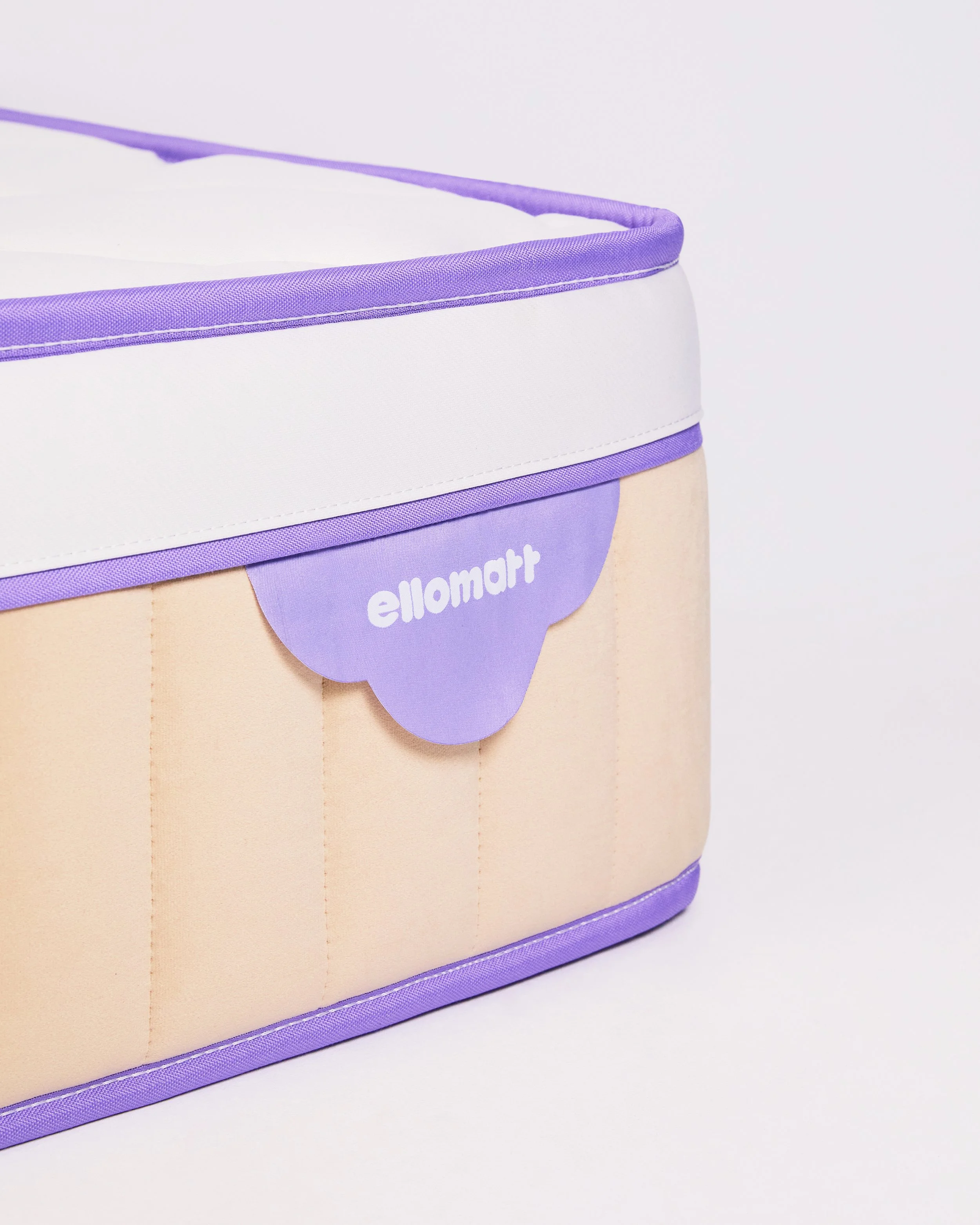 A pastel-colored storage bin with purple and white accents, and a purple cloud-shaped label with white text that reads 'ellomart'.