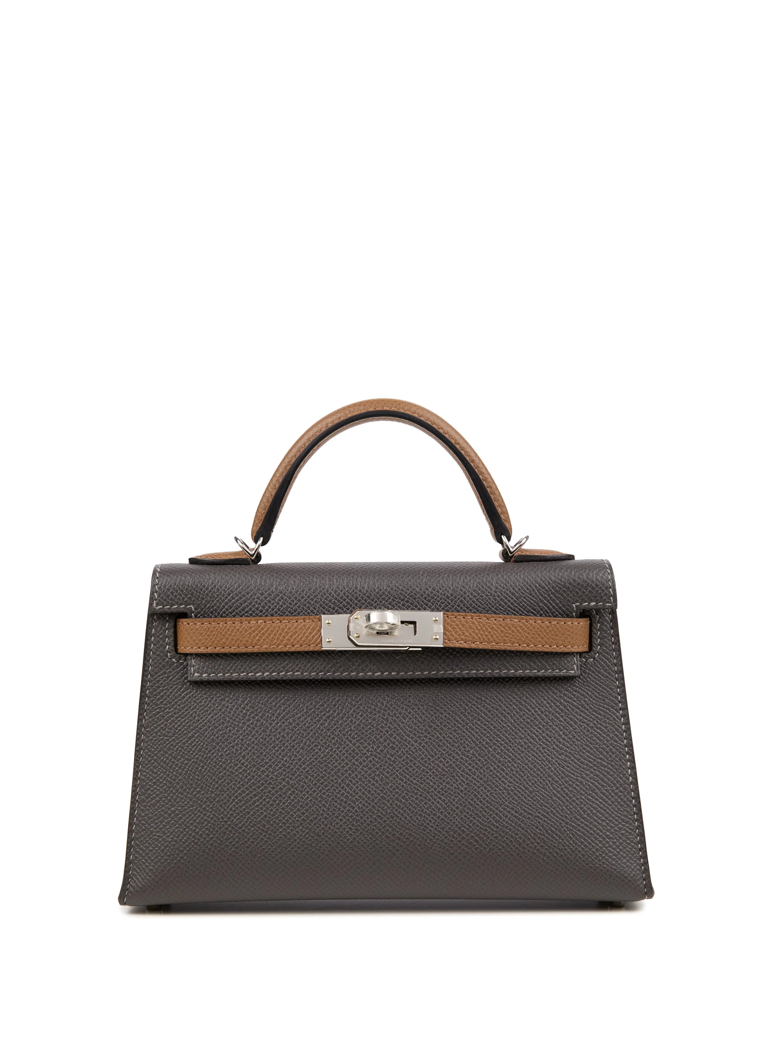 A black handbag with a brown handle and strap, featuring a silver clasp.