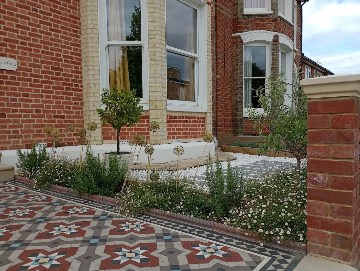 Planting design for a front garden with alliums and rosemary