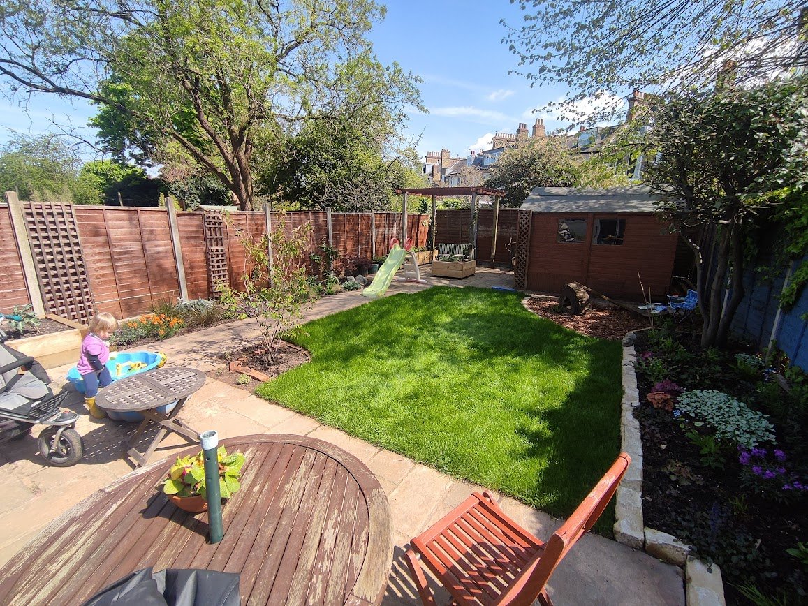 Family-friendly back garden design with lawn and play area