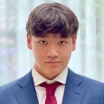 Portrait of a young man in a suit and red tie.