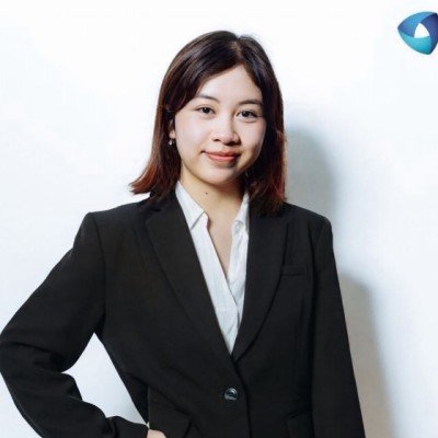 Portrait of a young woman with shoulder-length hair in a black blazer.