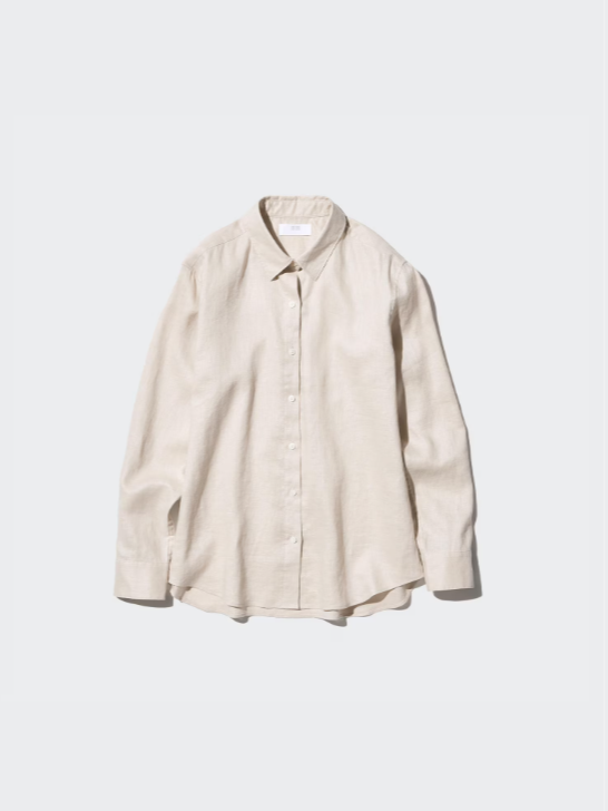 A cream-colored, long-sleeve button-up shirt on a plain light gray background.