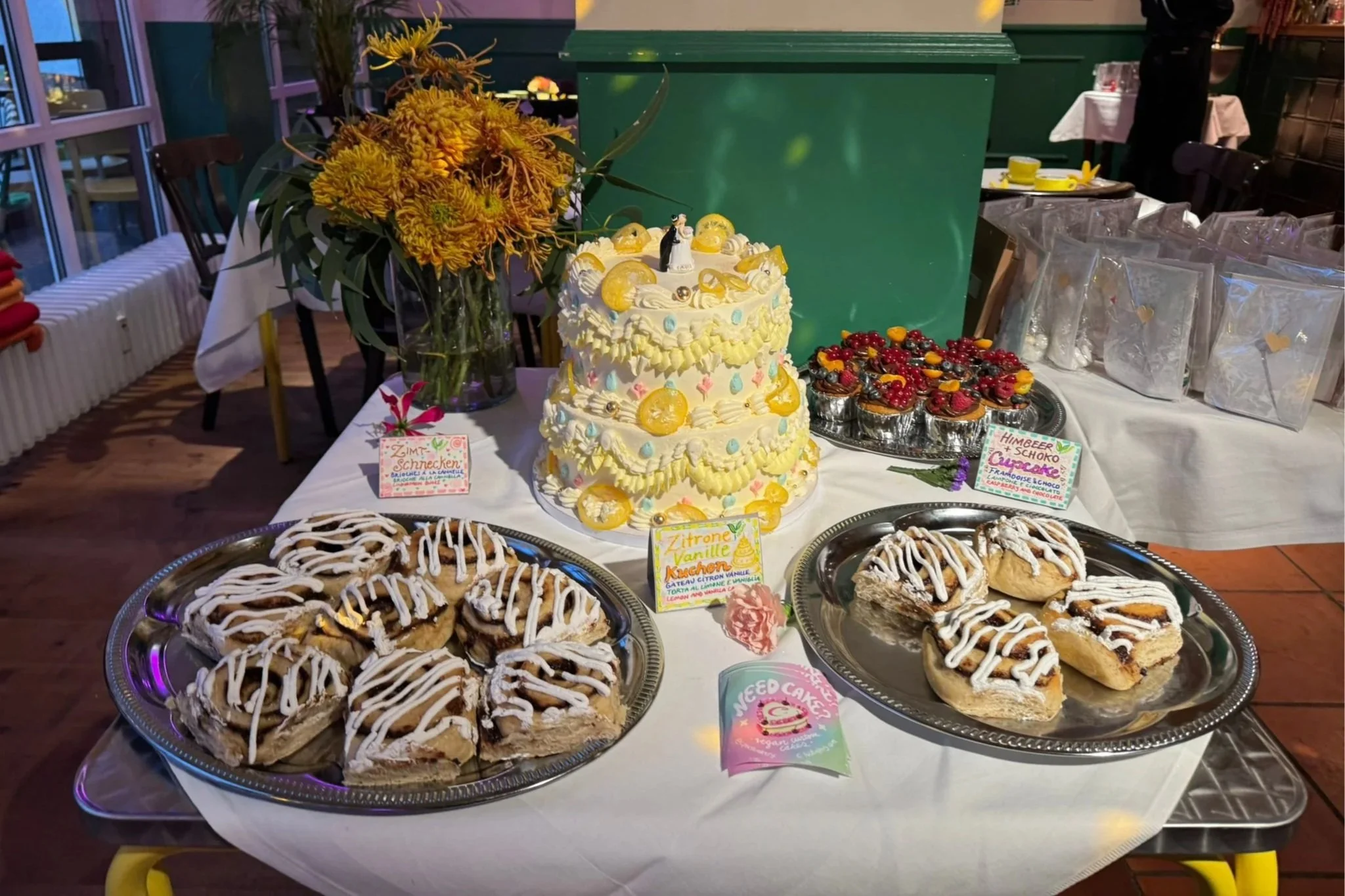 Assorted decorated cakes and cupcakes on gold and glass trays