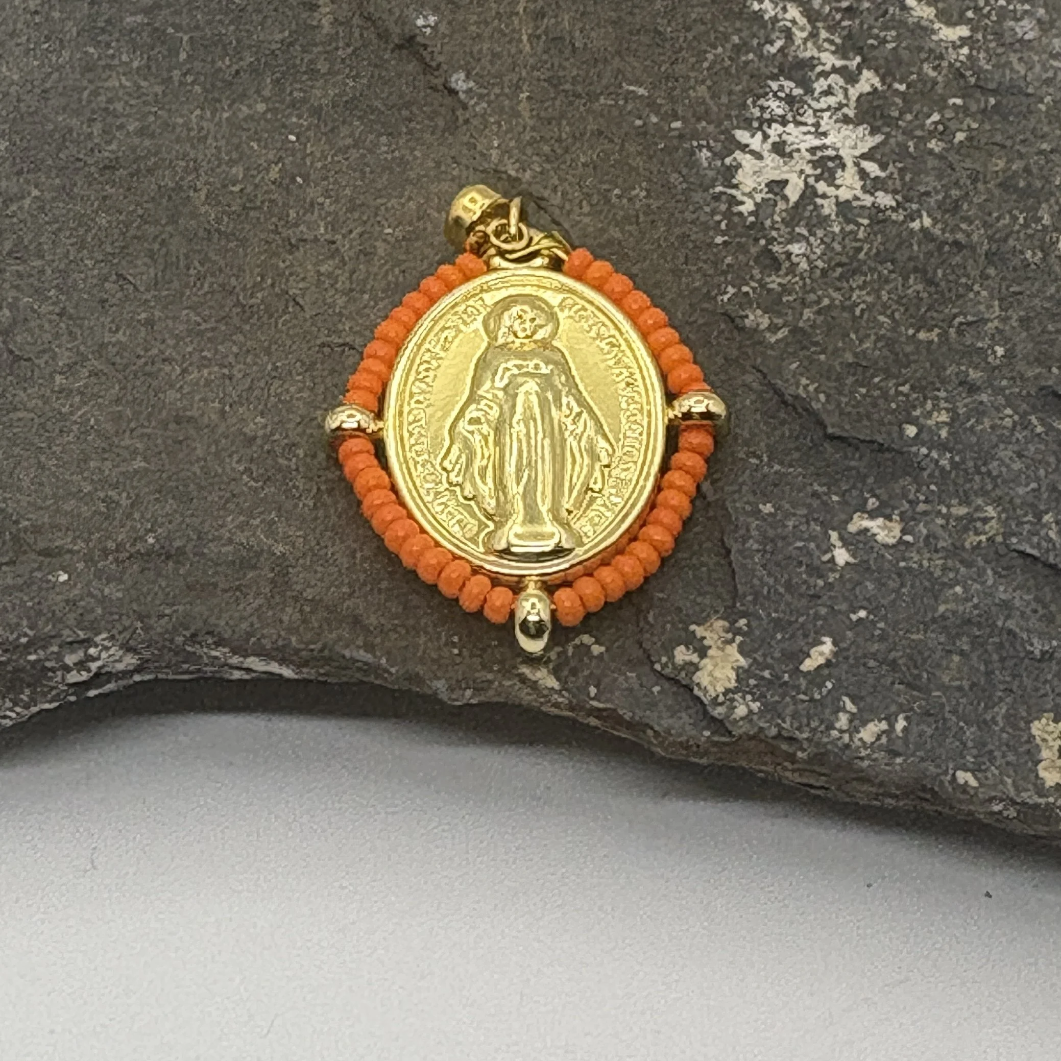 Oval 18K gold plated Virgin Mary charm with an orange bead surround
