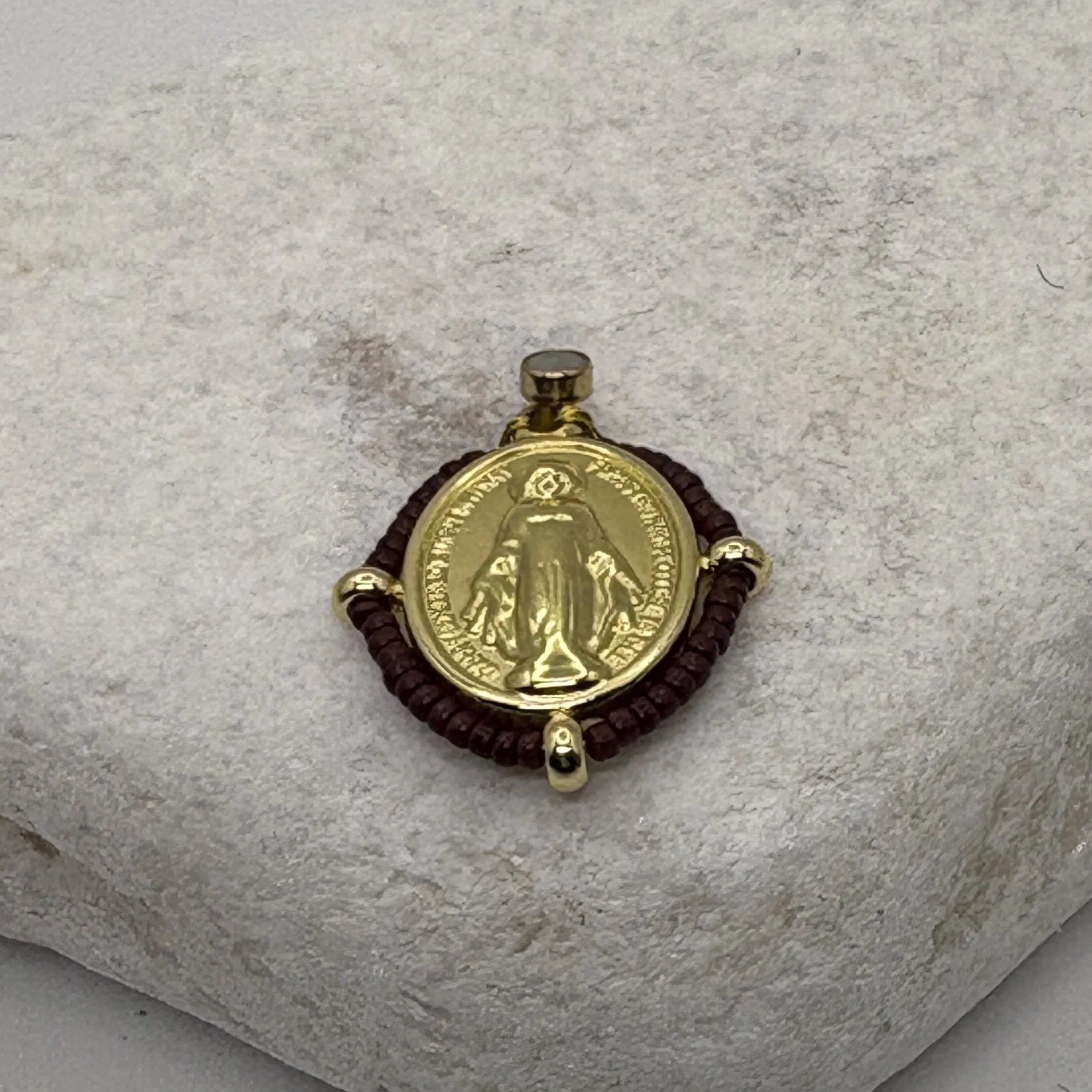 Oval 18K gold plated Virgin Mary charm with a brown bead surround