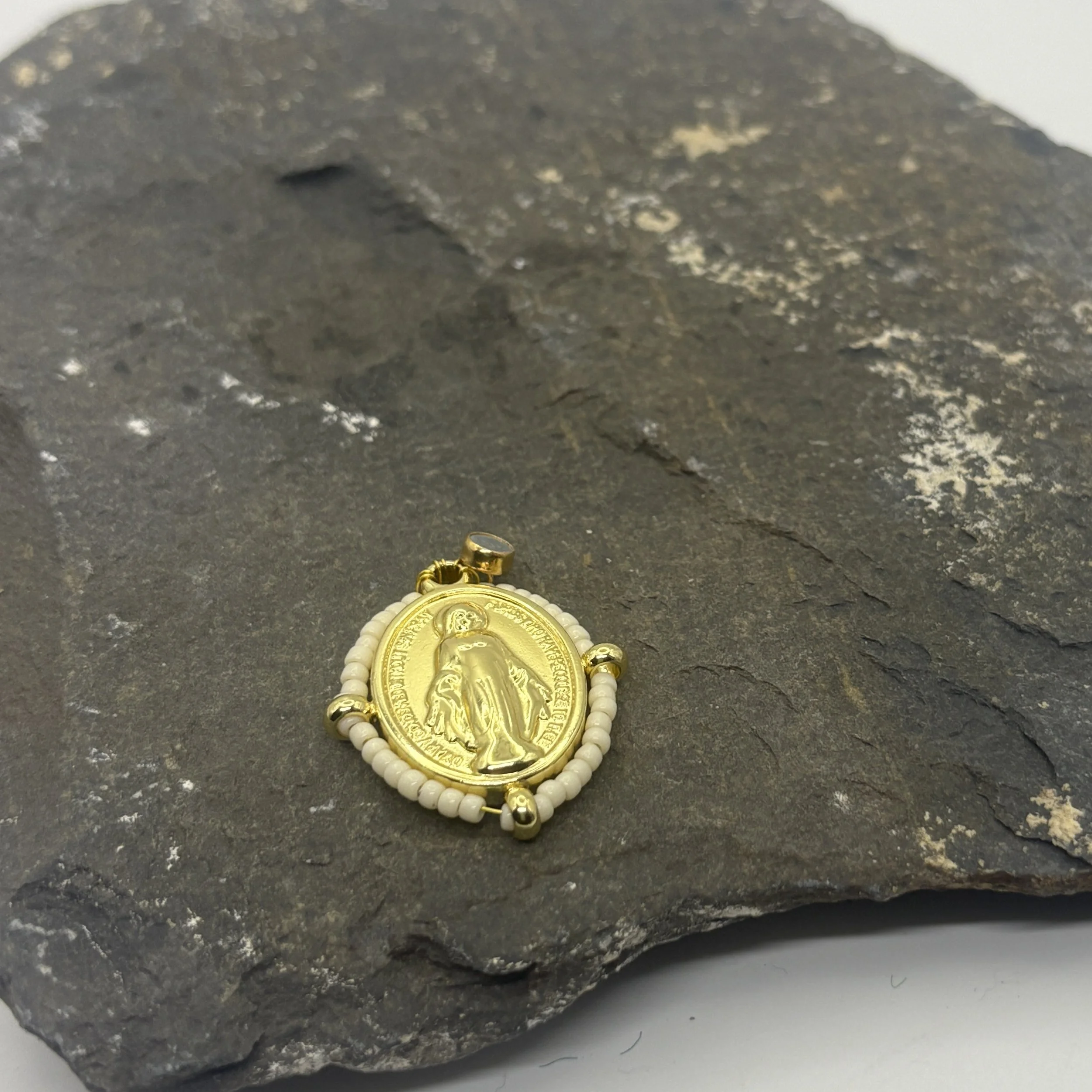 Oval 18K gold plated Virgin Mary charm with a cream glass bead