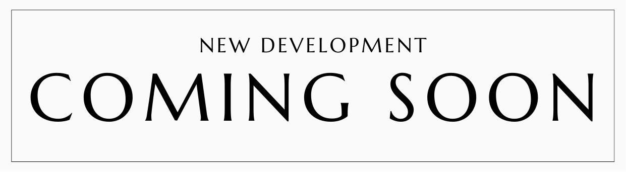 Sign with text 'New Development Coming Soon' indicating an upcoming real estate or construction project.