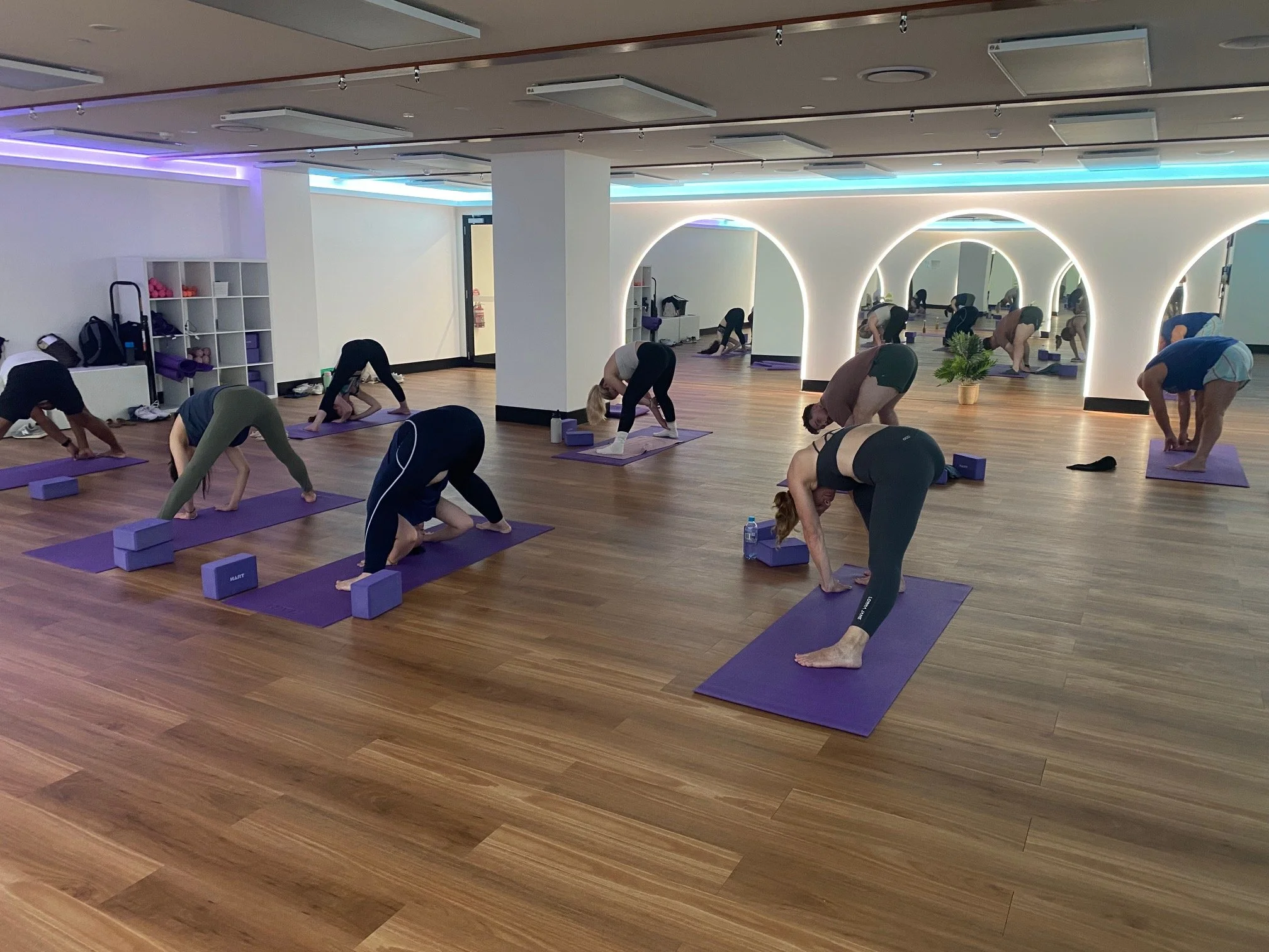 People participating in a yoga class at EMF Brisbane, hosted by Grace Tiong Yoga Instructor