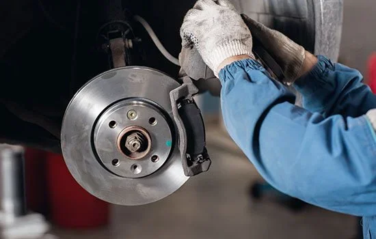 Mechanic installing new brakes