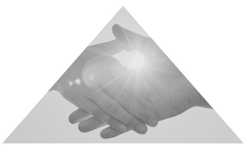Close-up of two hands clasped in a handshake with sunlight shining directly behind them.
