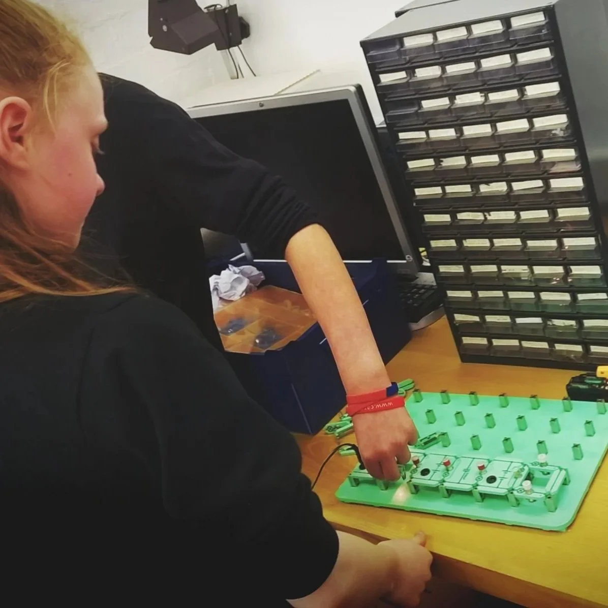 A girl modelling an electronic circuit