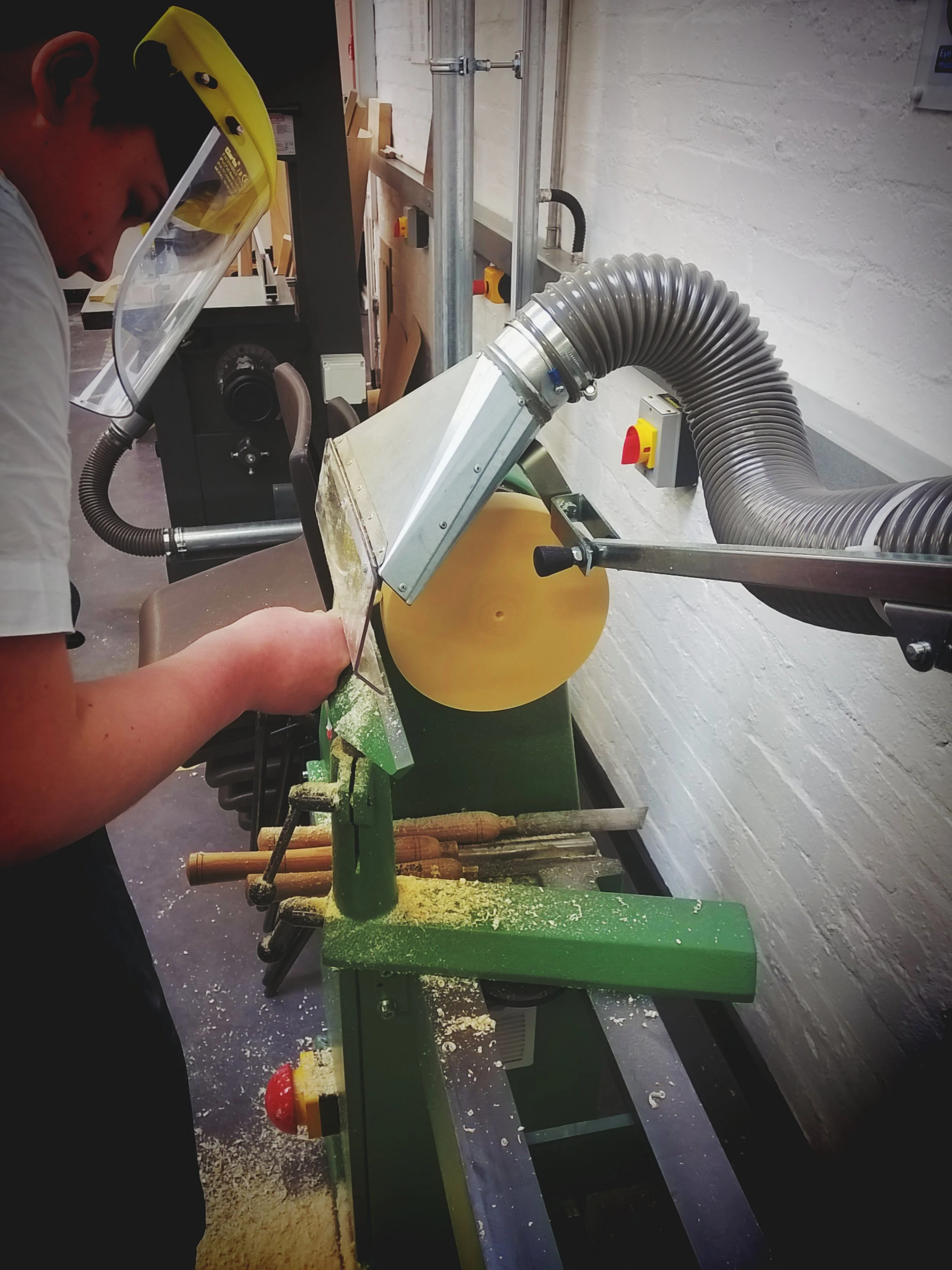 A male pupil using a lathe