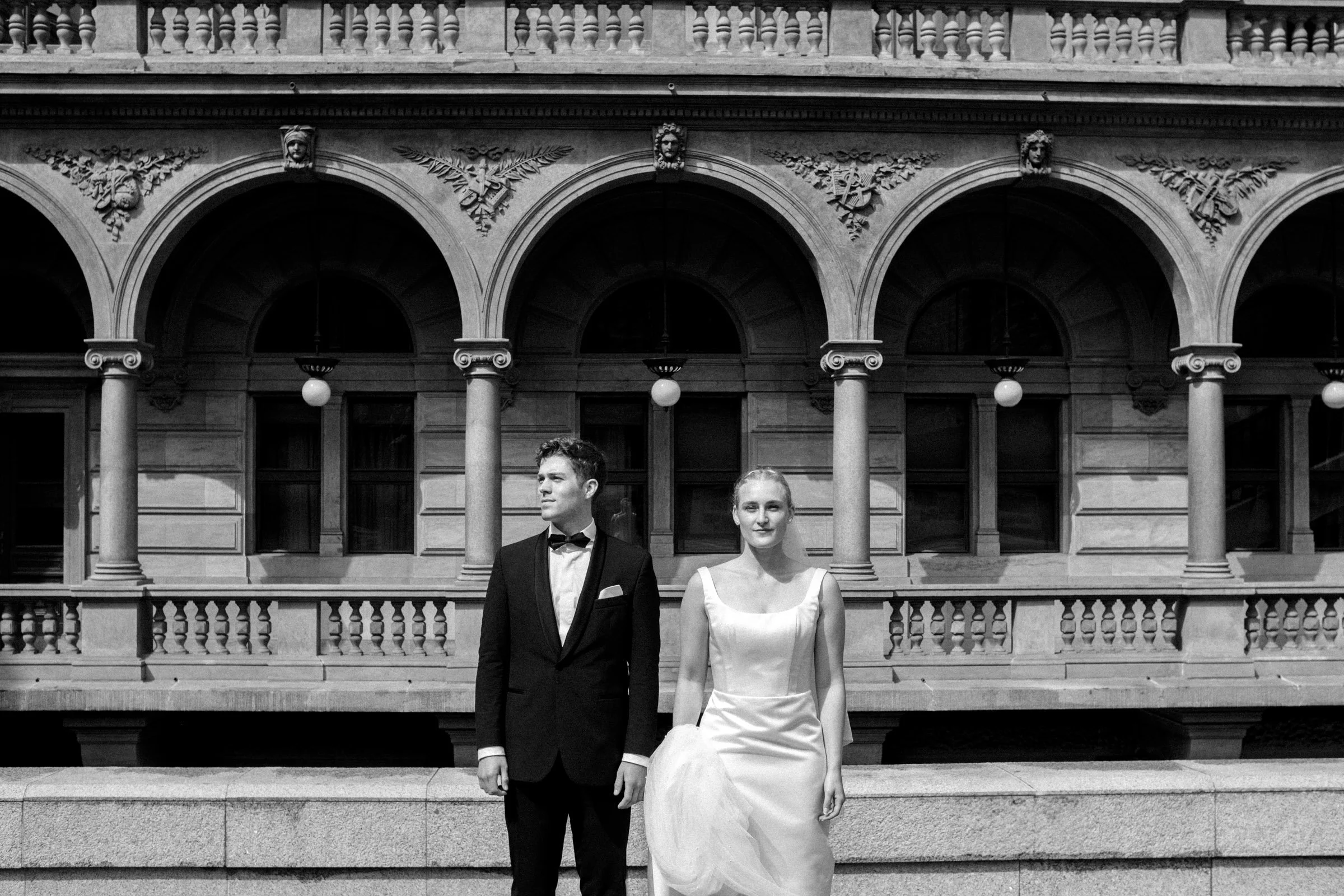 Prague elopement wedding photos of a couple in front of the National Theatre, taken by a Prague destination wedding photographer.