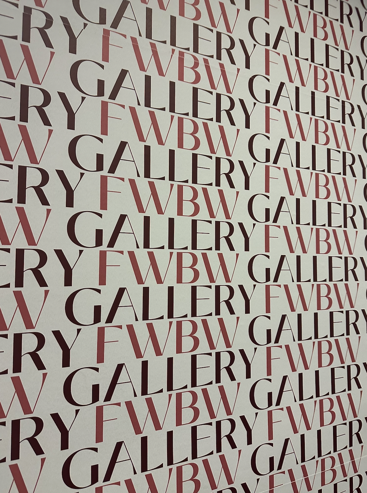 Pattern of repeated words 'GALLERY' and 'FWWB' in black and pink on a white background.
