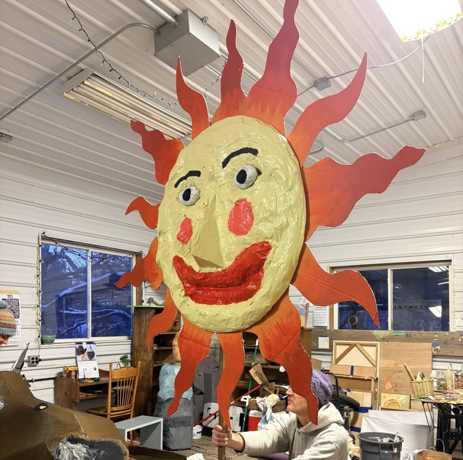 A large, colorful sun sculpture.