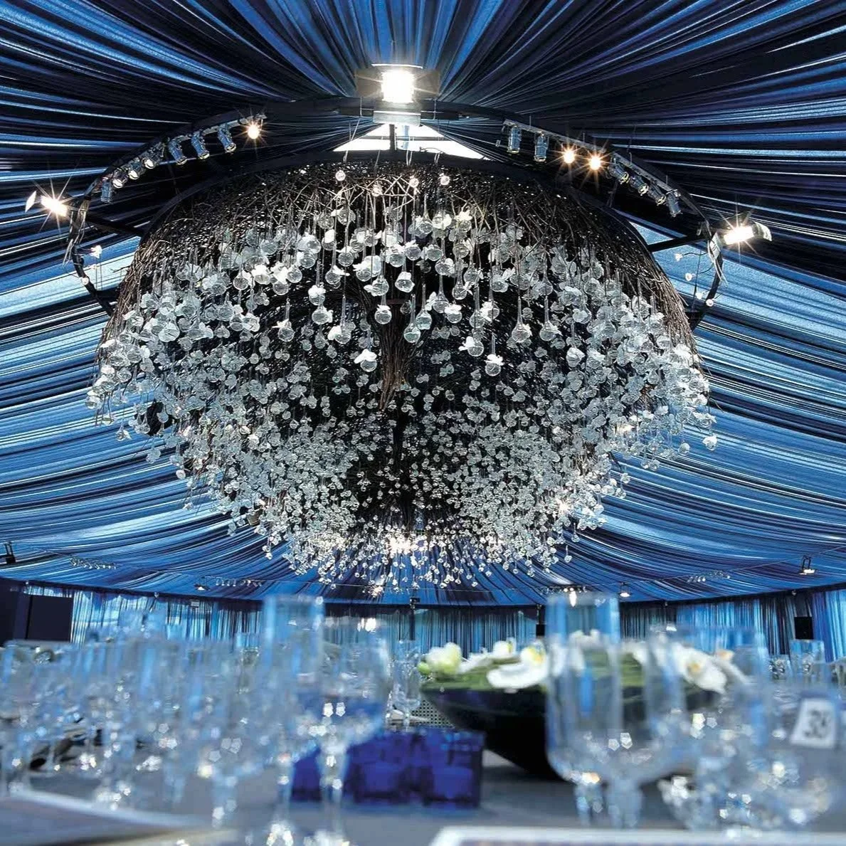 Daniel Ost hanging floral chandelier with hundreds of glass vases and flowers.