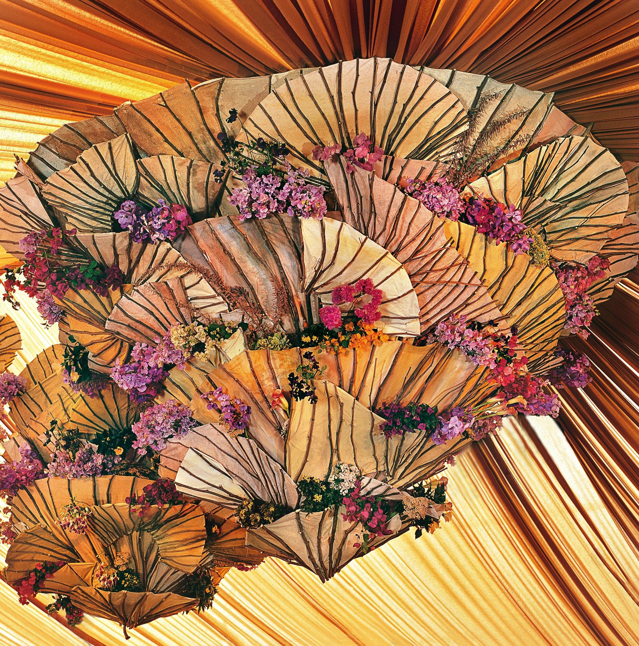 Artistic ceiling design of floral fans and blossoms creating a striking focal point at a corporate celebration.