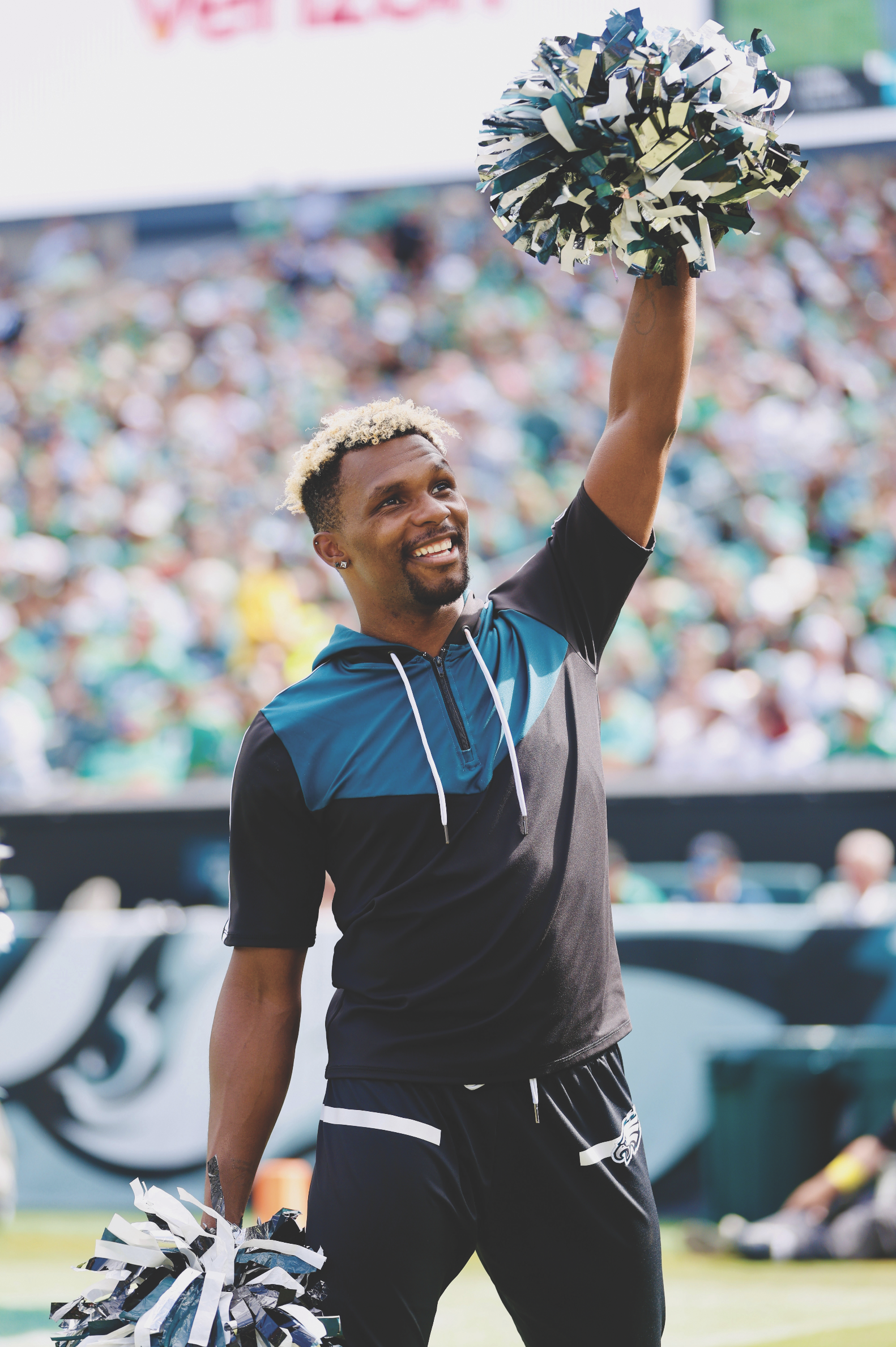  Left: James Lagette brings the energy to the field, joining the Philadelphia Eagles cheerleaders during a game-day celebration. Right:   LeGette poses with the Lombardi Trophy after the Eagles’ Super Bowl win.  