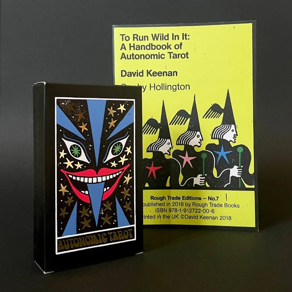 Deck of Autonomic Tarot cards and a yellow book titled "To Run Wild In It: A Handbook of Autonomic Tarot" by David Keenan, with a purple figure with stars on it