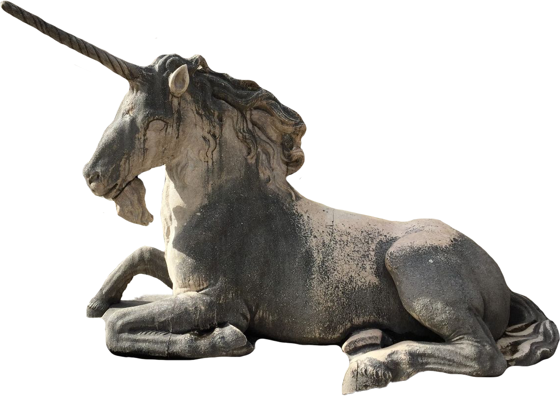 A stone sculpture of a reclining unicorn with a spiraled horn, ears, and flowing mane and tail.