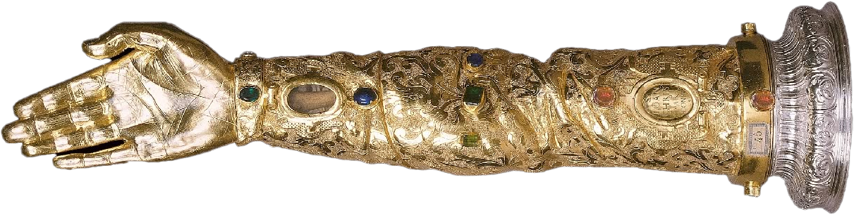 Gold arm and hand sculpture with intricate engravings and embedded gemstones, attached to a decorative base.