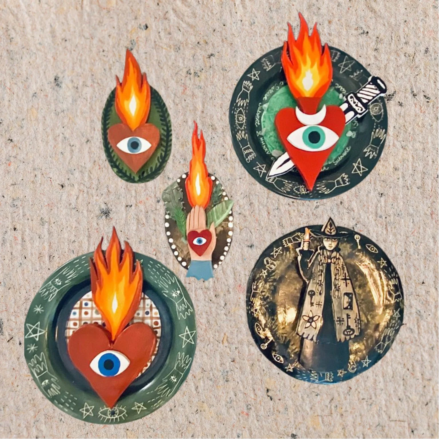 Various papel picado banners with eye and flame designs, and a tarot card depicting a wizard with flames.